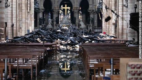 Fallen debris from the burned roof structure sits near the altar inside Notre Dame Cathedral.