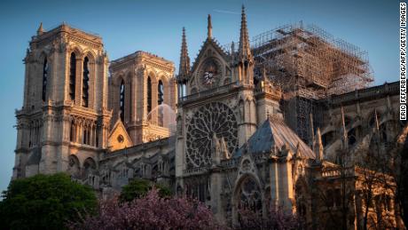 A firefighter pours water on Notre Dame cathedral in the aftermath of Monday&#39;s fire. 