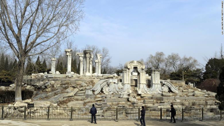 Tourist look at the ruins of the Guanshuifa Fountain which was built in 1759 during the period of Qing Emperor Qianlong, at the Old Summer Palace, also called Yuanmingyuan, in Beijing on February 24, 2009.