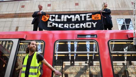 Activists glue themselves to London train on third day of climate protests