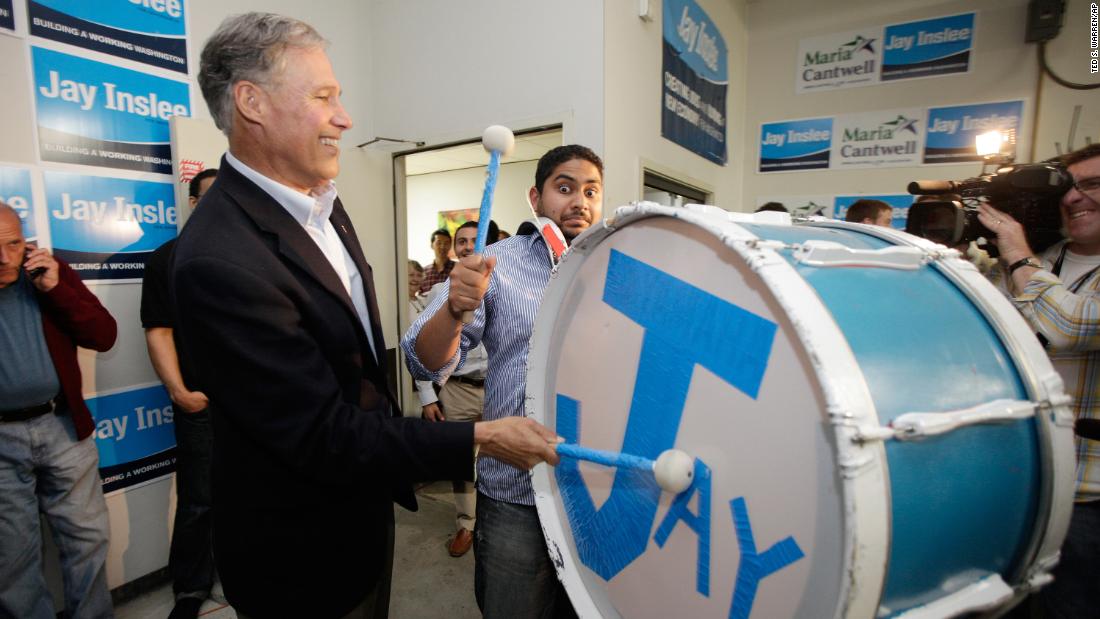 Inslee, running for governor, bangs on a drum while celebrating early election returns in 2012.