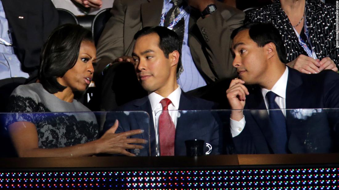 First lady Michelle Obama speaks with Julian Castro, center, and Joaquin Castro at the Democratic National Convention.