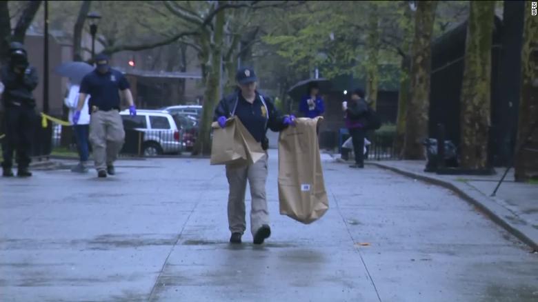 Crime technicians carried bags of presumed evidence to police vehicles.