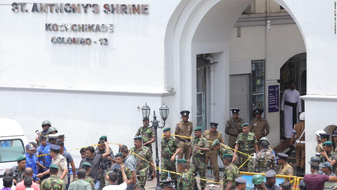 Sri Lankan military officers stand guard in front of St. Anthony&#39;s Shrine.