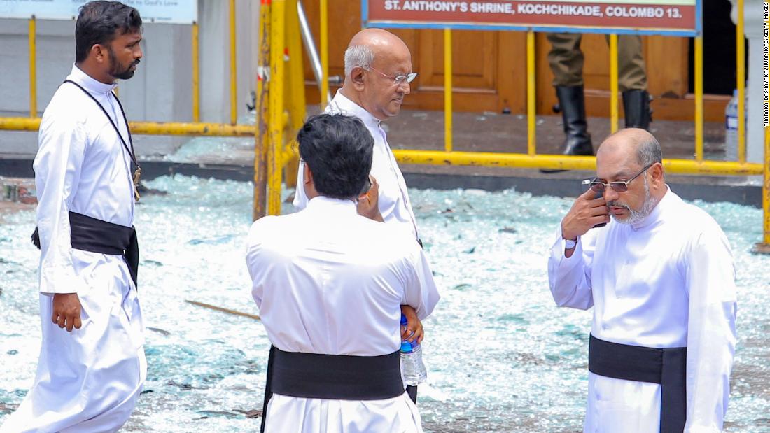 Priests view blast debris outside St. Anthony&#39;s Shrine.