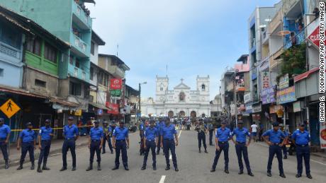 Sri Lankan security personnel keep watch outside a church in Colombo after a blast Sunday. 