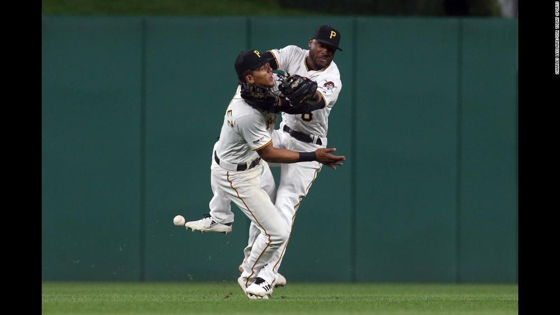 Pittsburgh Pirates shortstop Erik Gonzalez, left, and center fielder Starling Marte collide while chasing a fly ball against the San Francisco Giants on Friday, April 19, in Pittsburgh.