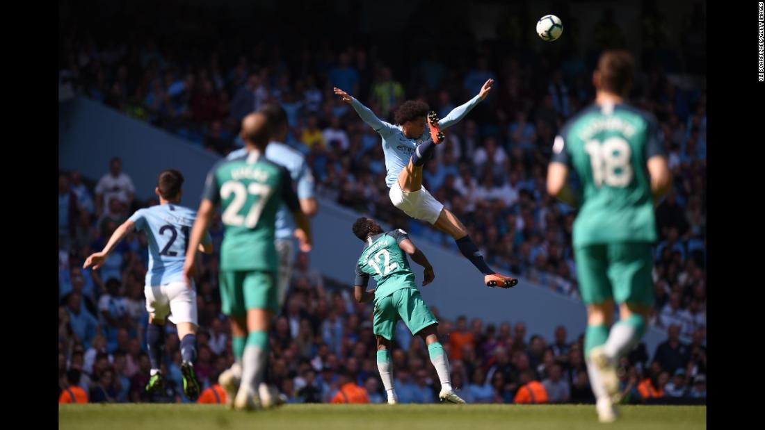 Manchester City&#39;s Leroy Sane jumps for the ball over Tottenham Hotspur&#39;s Victor Wanyama during the English Premier League football match on Saturday, April 20, in Manchester.