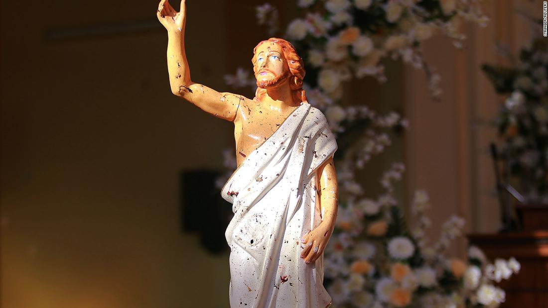 Blood stains are seen on a statue of Jesus Christ after a bomb blast inside a church in Negombo, on Sunday.