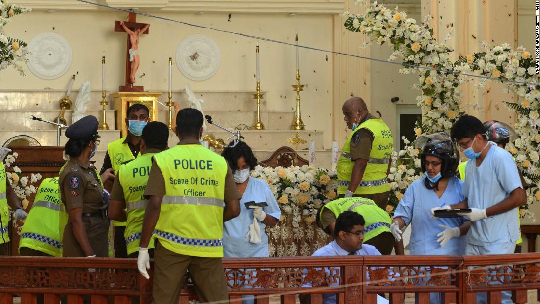 Police and forensics officials inspect the interior of St. Sebastian&#39;s Church in Negombo on Monday.