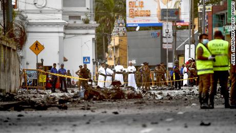 Sri Lankan priests look at the debris of a car after it explodes when police tried to defuse a bomb near St. Anthony&#39;s Shrine a day after the Easter Sunday  attacks.