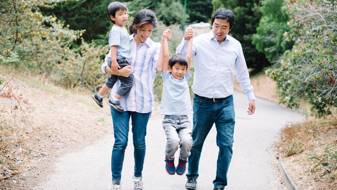 Yang and his wife, Evelyn, walk with their two sons.