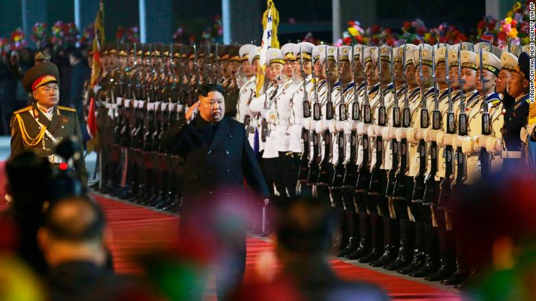 In this photo provided by the North Korean government, North Korean leader Kim Jong Un inspects an honor guard at an undisclosed train station in North Korea on Wednesday before leaving for Russia.