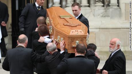 McKee&#39;s coffin is carried into the funeral service.