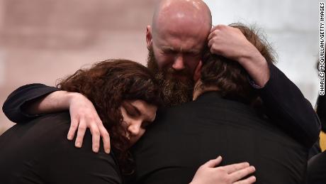 Mourners embrace during the service for killed journalist Lyra McKee.