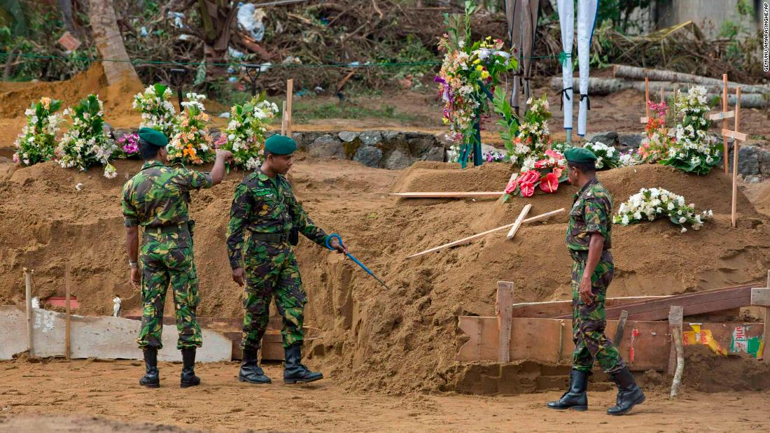 Members of a security task force search for explosives ahead of victims&#39; mass burials in Negombo on Wednesday.