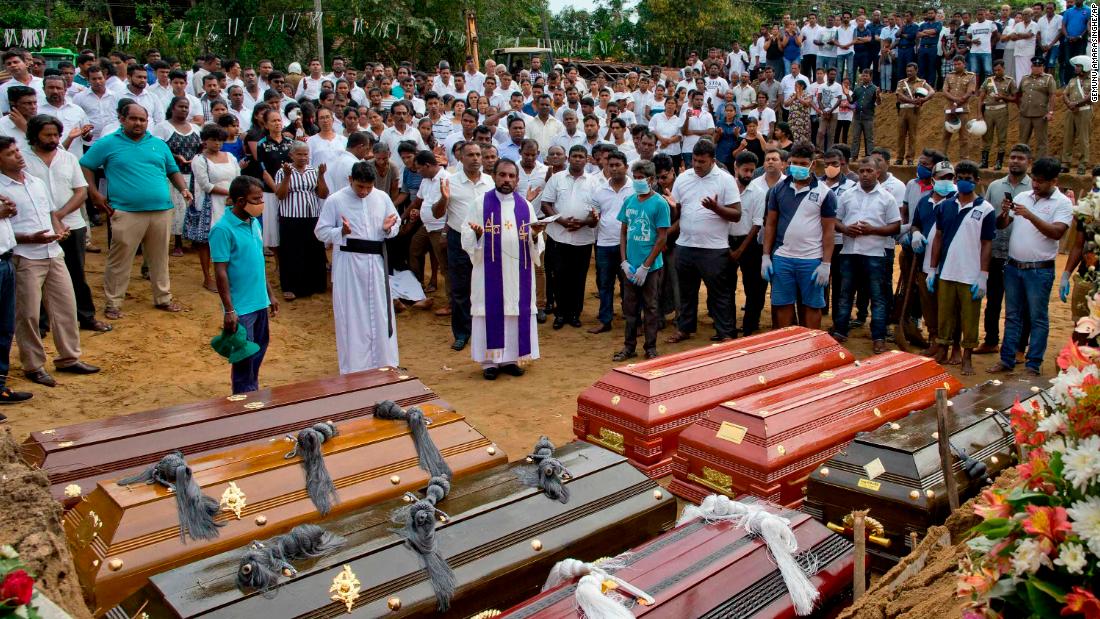 A priest conducts a burial ceremony for victims of the Easter Sunday bombings in Negombo, Sri Lanka, on Wednesday, April 24.