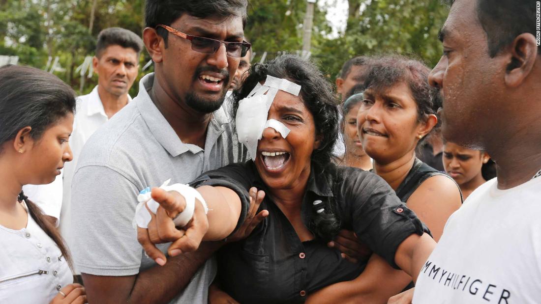 A woman who lost her husband and two children during the bombing at St. Sebastian&#39;s Church in Negombo yells toward the grave site during a mass burial on Wednesday.