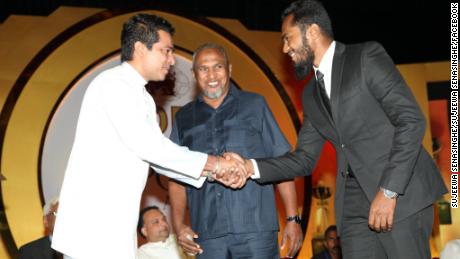 Spice trader Mohamed Ibrahim, center, looks on as his son Imsath is congratulated by a government mninister in 2016.