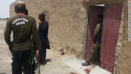 Pakistani security officials gather at the site of an attack by gunmen on a polio vaccination team in Balochistan province on Thursday.