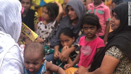 Women and children wait at a local school after being evacuated.