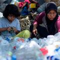 LHOKSEUMAWE, ACEH, INDONESIA - 2019/04/21: Mother and child seen cleaning plastic bottles for sale at a garbage dump site in Lhokseumawe, Aceh province, Indonesia.
Based on a study by McKinsey and Co. and Ocean Conservancy, Indonesia is the number two plastic waste producing country in the world after China. The large amount of waste production, especially plastics sent to the Indonesian seas, directly contributes to making coastal areas and small islands dirty and full of garbage. Moreover, from the results of the study, it was found that the waste in the coastal area was dominated by plastic with a percentage of 36 to 38 percent. (Photo by Zikri Maulana/SOPA Images/LightRocket via Getty Images)