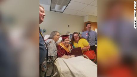 Family and friends gather around Johnson to celebrate his graduation.