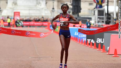 Kenya&#39;s Brigid Kosgei crosses the finish line to win the women&#39;s race.