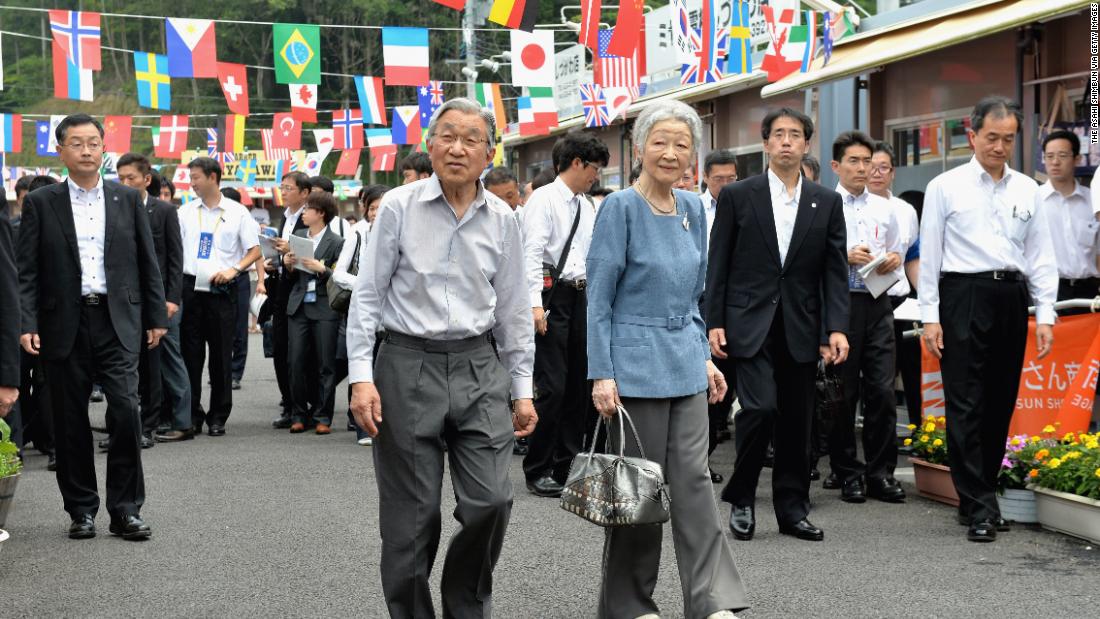 Akihito and Michiko tour shops in Minamisanriku, Japan, in July 2014. They offered encouragement to store owners who were affected by the earthquake and tsunami in 2011.