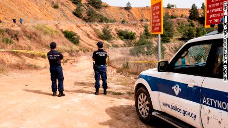 Cypriot forensic police cordon off a suspected dump site at Mitsero Red Lake on April 26, 2019.