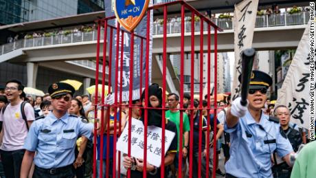 Protesters take part in a march against the proposed extradition law as they hold placards and march on the street on April 28, 2019 in Hong Kong, China. 