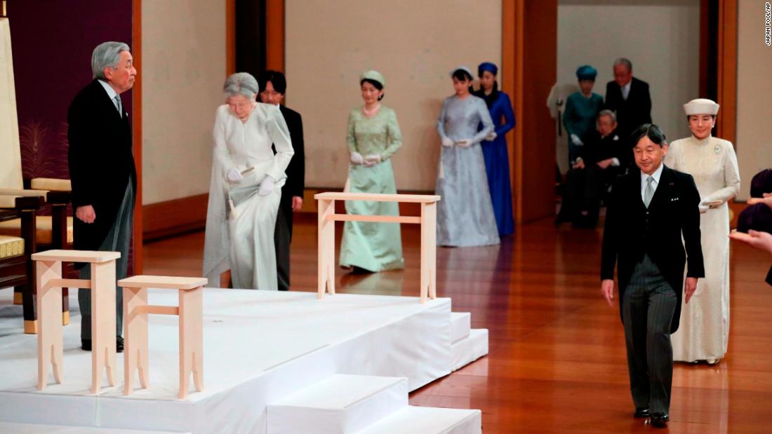 Crown Prince Naruhito walks in front of his father as he arrives for the abdication ceremony.