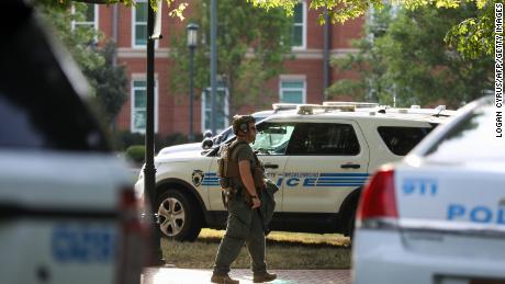 A medic walks between police cars after a shooting on the campus of University of North Carolina Charlotte. 