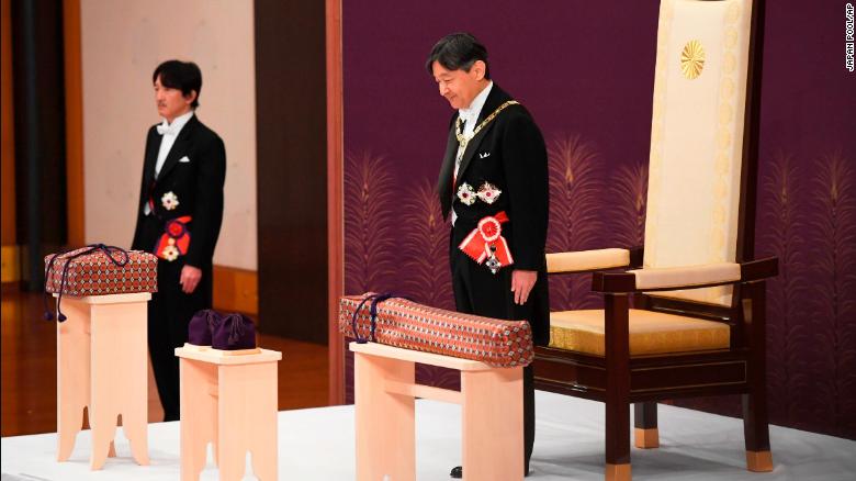 Japan's new Emperor Naruhito receives the Imperial regalia of sword and jewel as proof of succession at the ceremony at Imperial Palace in Tokyo, Wednesday, May 1, 2019. Standing at left is Crown Prince Akishino.