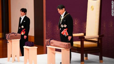 Japan&#39;s new Emperor Naruhito receives the Imperial regalia of sword and jewel as proof of succession at the ceremony at Imperial Palace in Tokyo, Wednesday, May 1, 2019. Standing at left is Crown Prince Akishino.