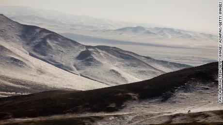 A Mongolian herder on horseback searches for his livestock along the frozen landscape in Bayantsogt, Tuv province in Mongolia.