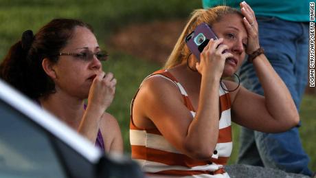 Family members and friends wait for their loved ones after the shooting. 