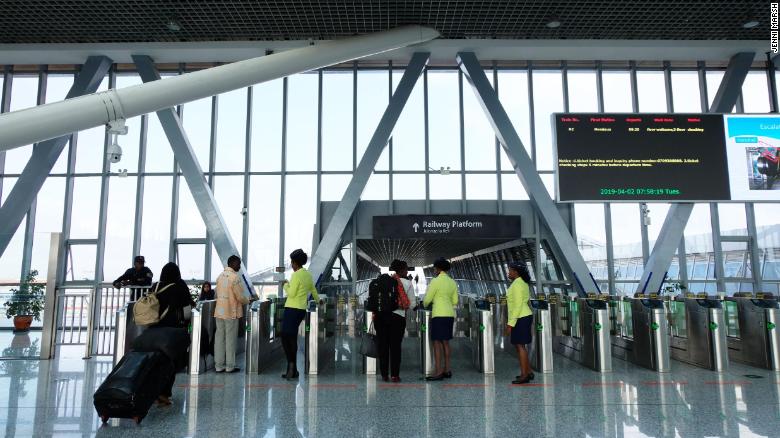 Passengers show their tickets inside the modern terminal.