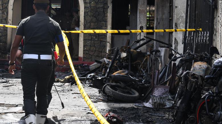 Sri Lankan security personnel walk past debris outside Zion Church following an explosion in Batticaloa in eastern Sri Lanka on April 21, 2019. 