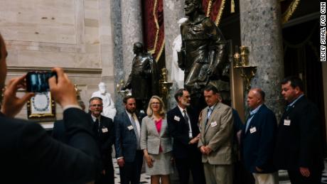 Miller takes a photo with members of the West Virginia State Building and Construction Trades Council in the Capitol building&#39;s Statuary Hall.