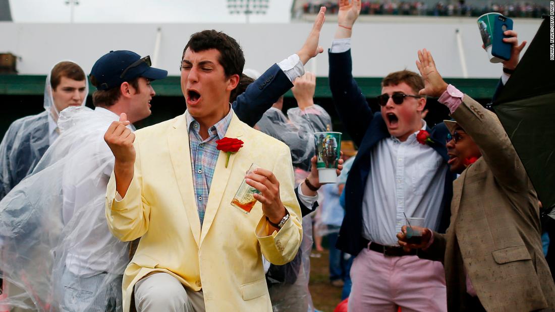 Fans react to a race prior to the Kentucky Derby at Churchill Downs.