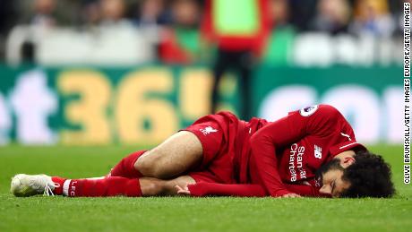 Mohamed Salah of Liverpool goes down injured during win at Newcastle.