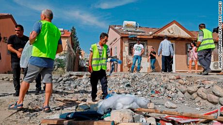 People inspect damage at a house in the southern Israeli city of Beersheba on May 5, 2019, after it was hit in a rocket strike from Gaza. 