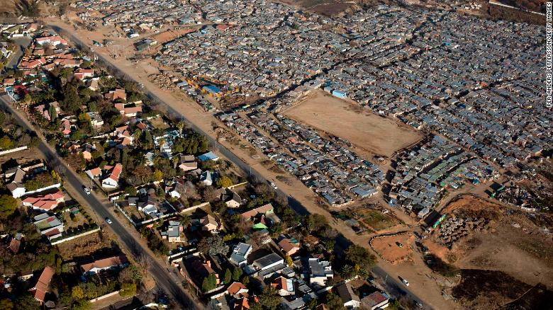 In South Africa, the divide between rich and poor is visible from the sky. On the left is Bloubusrand in Johannesburg, a middle class area with larger houses and pools. On the right is Kya Sands informal settlement. 