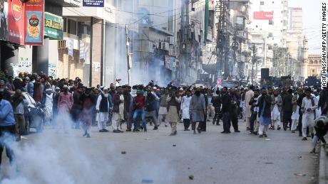 Pakistani Islamists react after the police use tear gas during a protest against the Supreme Court decision on Asia Bibi&#39;s case.