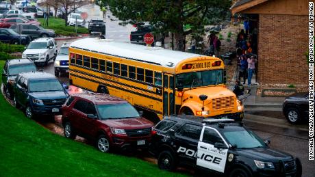 A bus evacuating students arrives at the Recreation Center at Northridge after a shooting at STEM School Highlands Ranch.