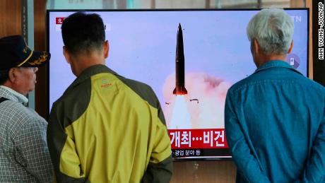 People watch a TV showing a file photo of North Korea&#39;s weapon systems during a news program at the Seoul Railway Station in Seoul, South Korea.