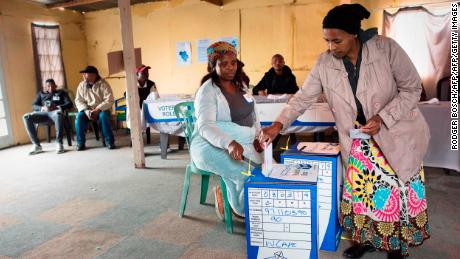 A woman casts her vote in a large shack being used as a voting station in an impoverished area in Khayelitsha on May 8, 2019 in Cape Town during South Africa&#39;s national and provincial elections. - South Africans began voting today in national elections which the ruling ANC, in power since 1994, is favourite to win despite corruption scandals, sluggish economic growth and record unemployment. The ANC has won all the past five elections, but today&#39;s vote is set to be an electoral test on whether the party has staunched a decline in popularity. (Photo by RODGER BOSCH / AFP)        (Photo credit should read RODGER BOSCH/AFP/Getty Images)