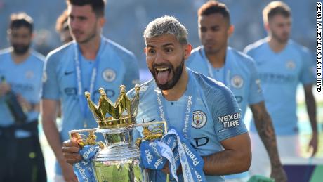 Sergio Aguero holds the Premier League trophy.