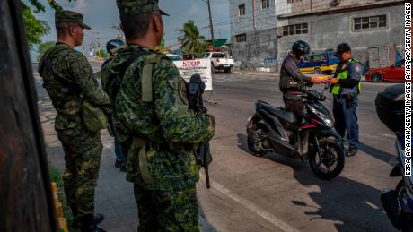 Military and police set up a checkpoint as part of security measures ahead of the midterm elections in Quezon city, Metro Manila.